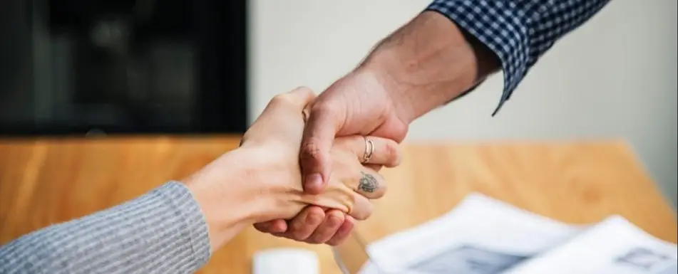 Two people shaking hands.