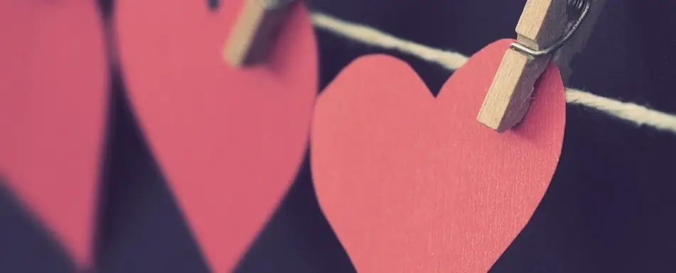 Heart cut-outs pinned on a rope.