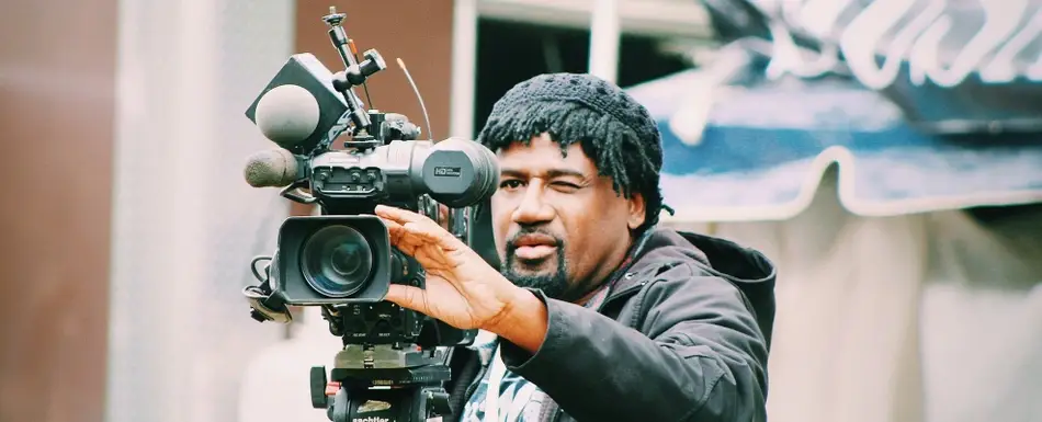 A man adjusts a professional film camera, image for the blog post "What If My Undergraduate Degree is Unrelated to What I Want to Study in Grad School?"