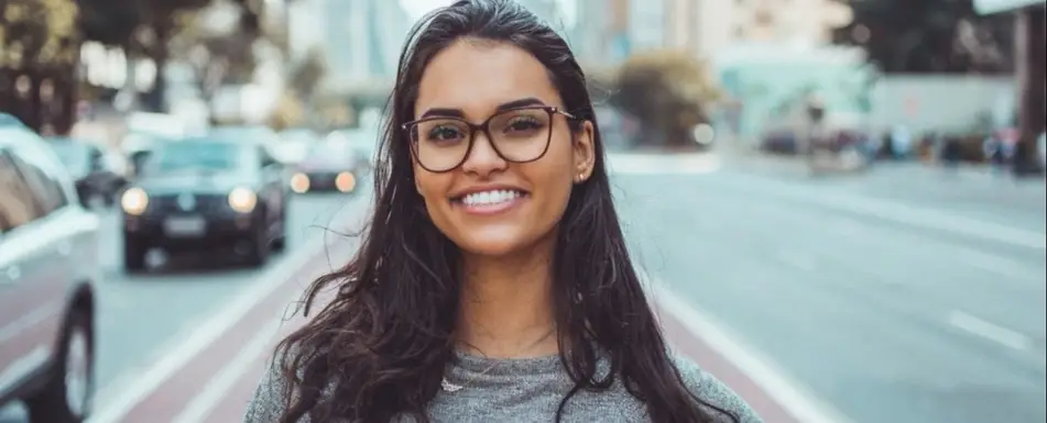 A Brown woman smiling.