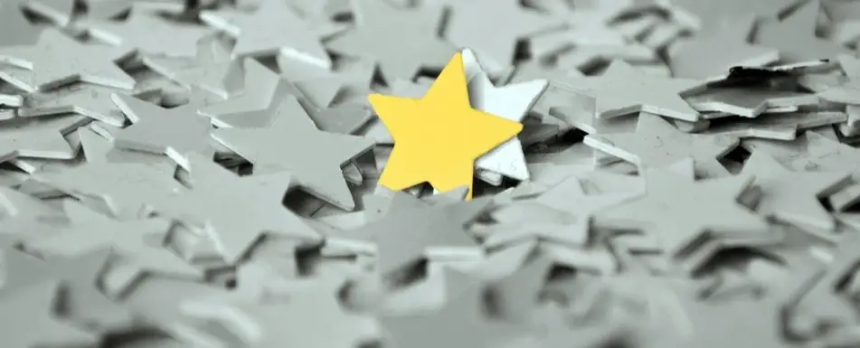 A bunch of grey stars and one yellow one.