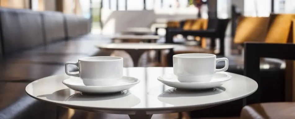Two cups of coffee on a table.