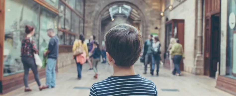 boy looking down a museum hallway