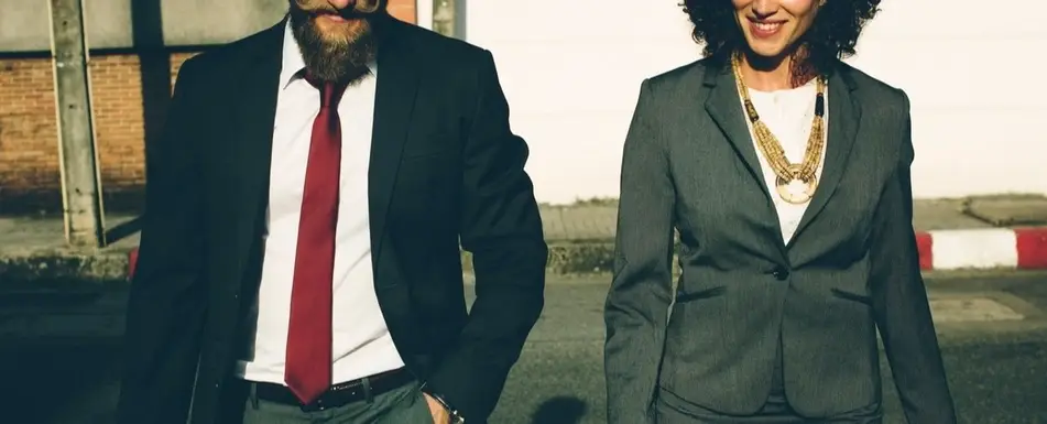 Two people dressed in suits.