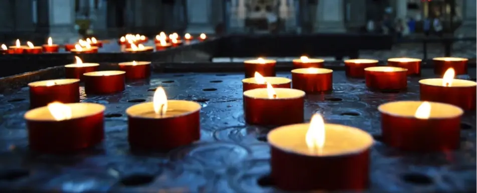 A close up of tea light candles.