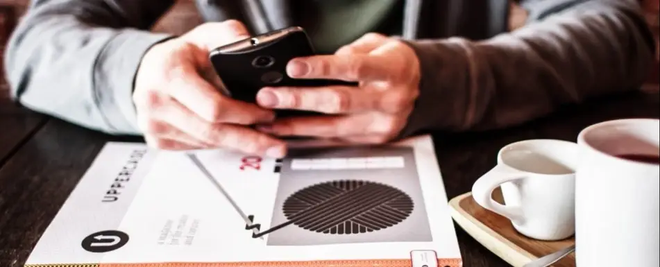 Someone typing on a smartphone.