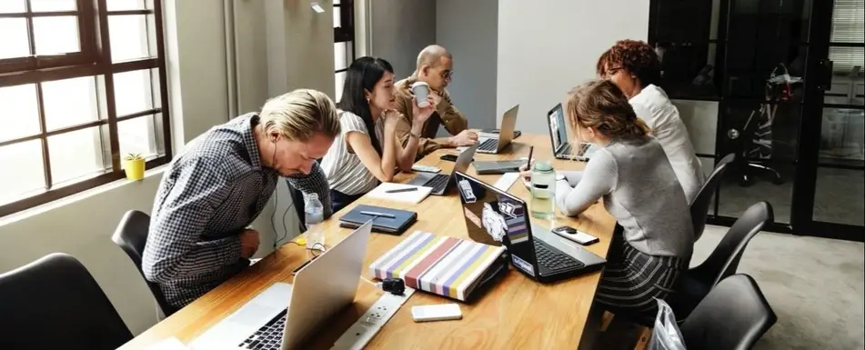 A group of people working in a conference room.