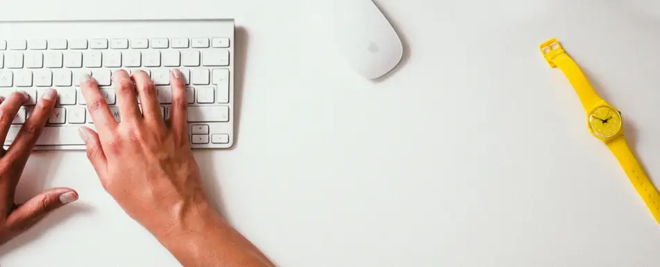 hands typing on computer