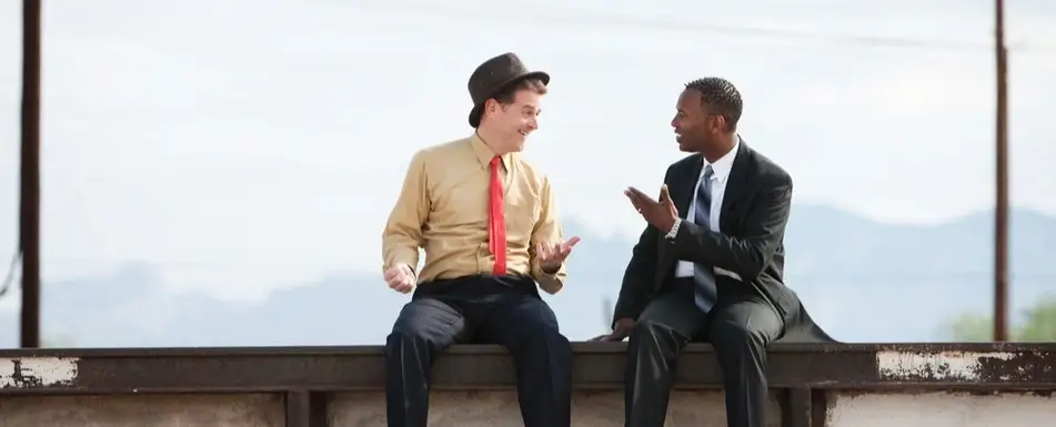 Two people sitting and talking.