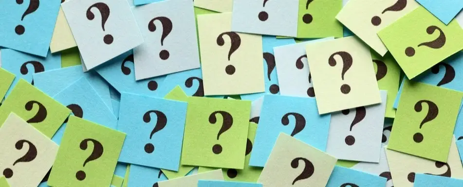 A bunch of colored papers with question marks on them.
