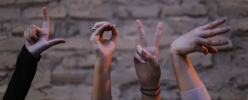 People spelling the word love with their hands.