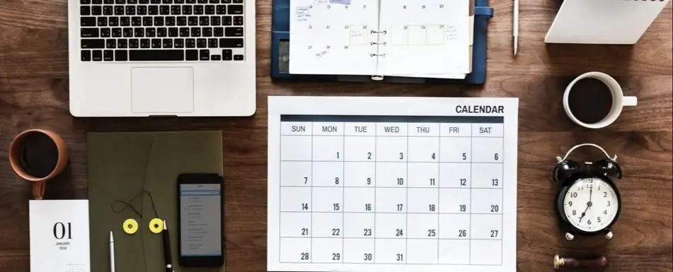 A desk covered in organized office supplies.
