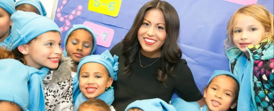 Jacqueline Kling posing with a group of children.