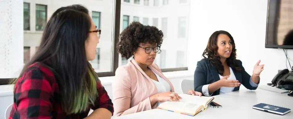 Three women having a discussion at a table