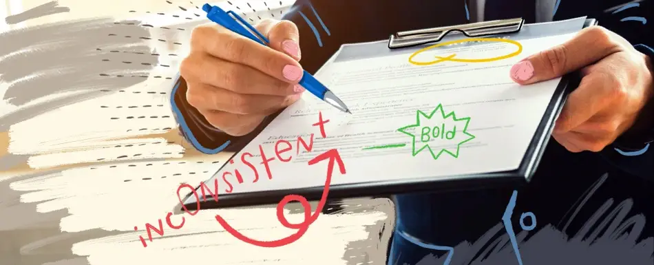 Someone fixing a resume that's covered in cartoons.