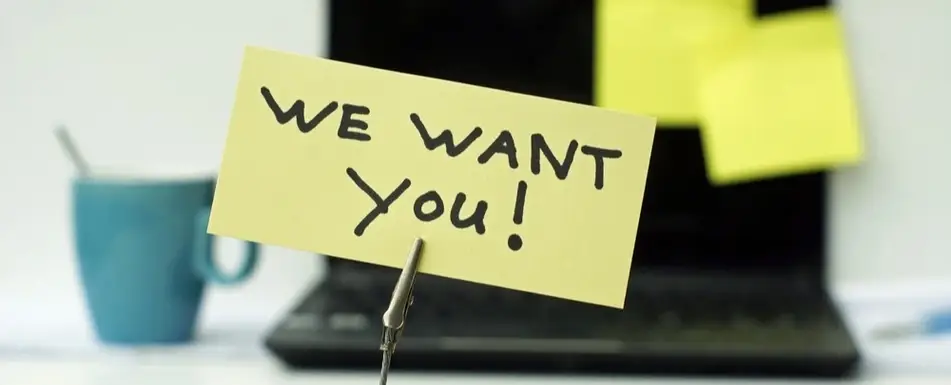 A post with 'We Want You!' written on it with a marker.
