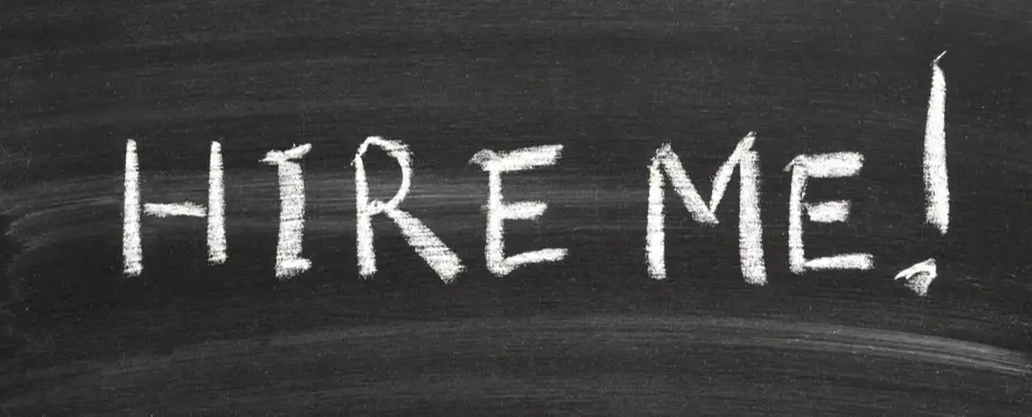 The words, "Hire me" on a chalkboard.
