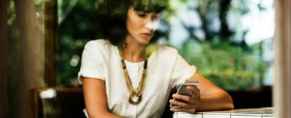 A woman looking at her smartphone.