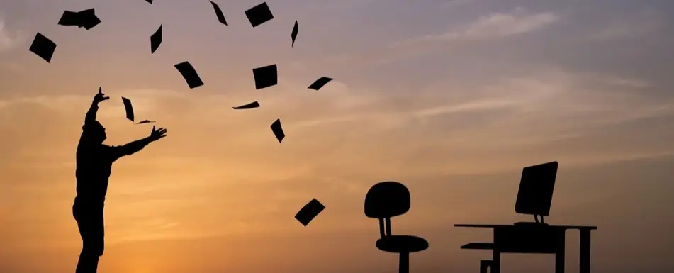 A person throwing a bunch of paper in the air.