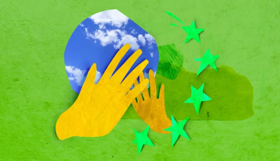 Image of construction paper hands holding a photo of the sky shaped like a globe.