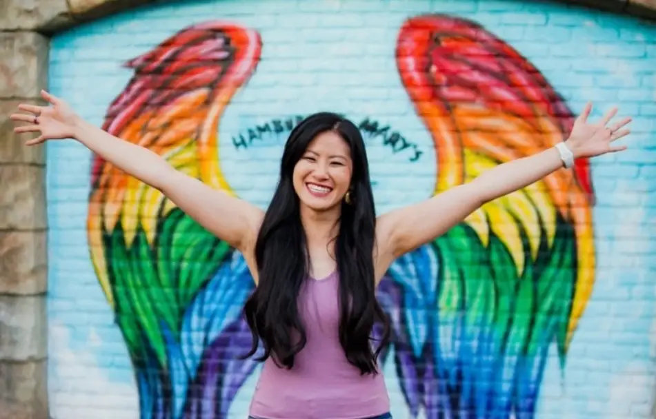 woman with her arms raised up