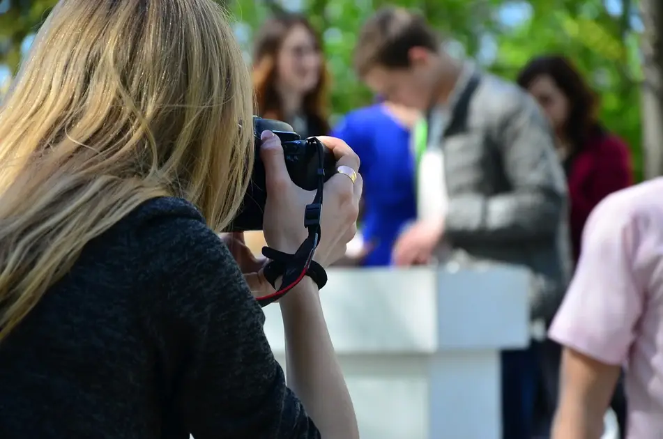 Photographer takes photos for social media at event