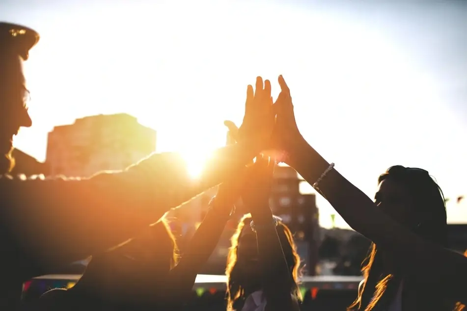 Backlit group high five