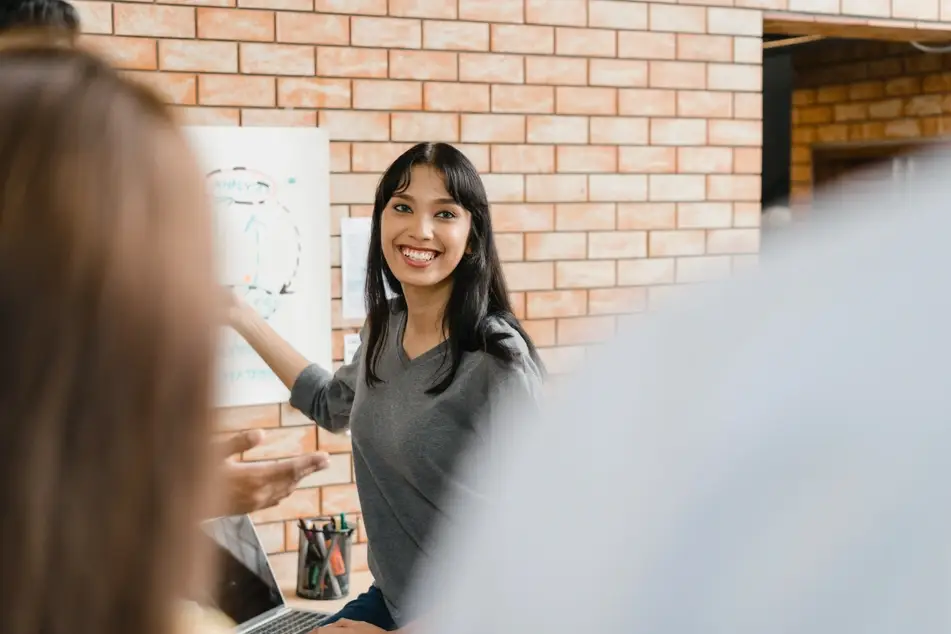 Woman smiles at co-workers at office