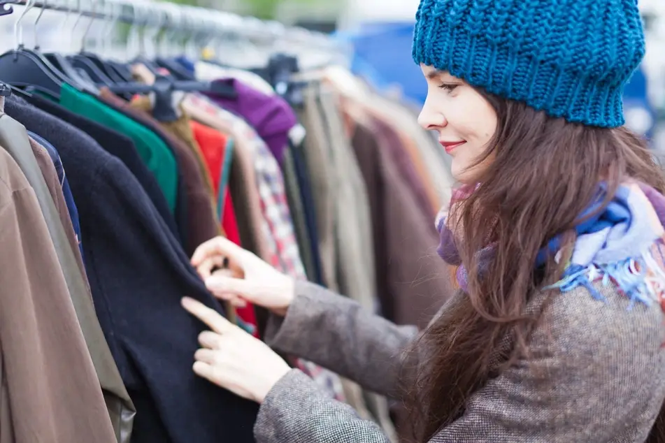 a woman volunteers at a thrift store