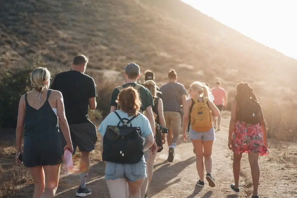 Group of people walking on a trail