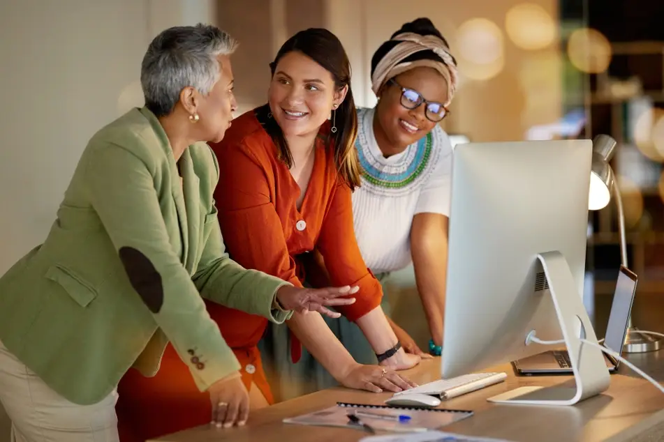 Group of women who are colleagues chat about a work assignment