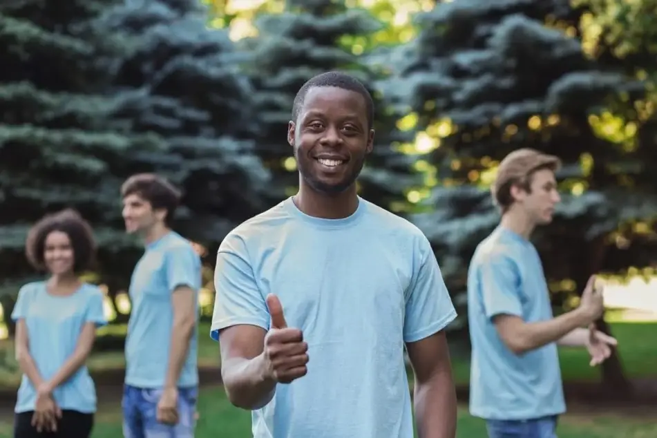 Smiling person giving a thumbs up