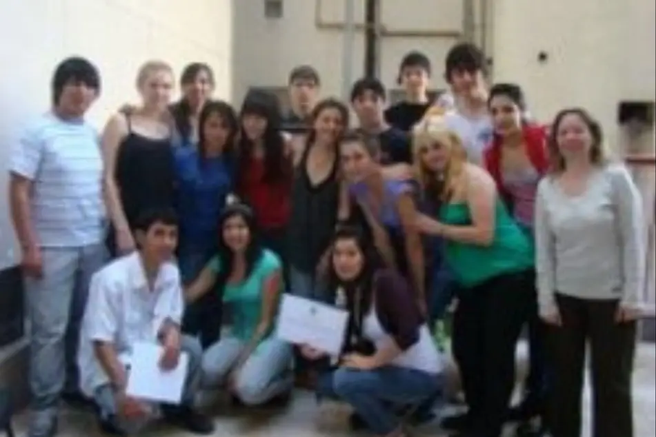 A group of fifteen volunteers pose for a photo.