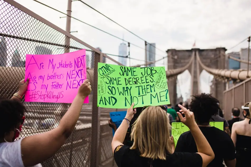 protesters hold signs at black lives matter protest