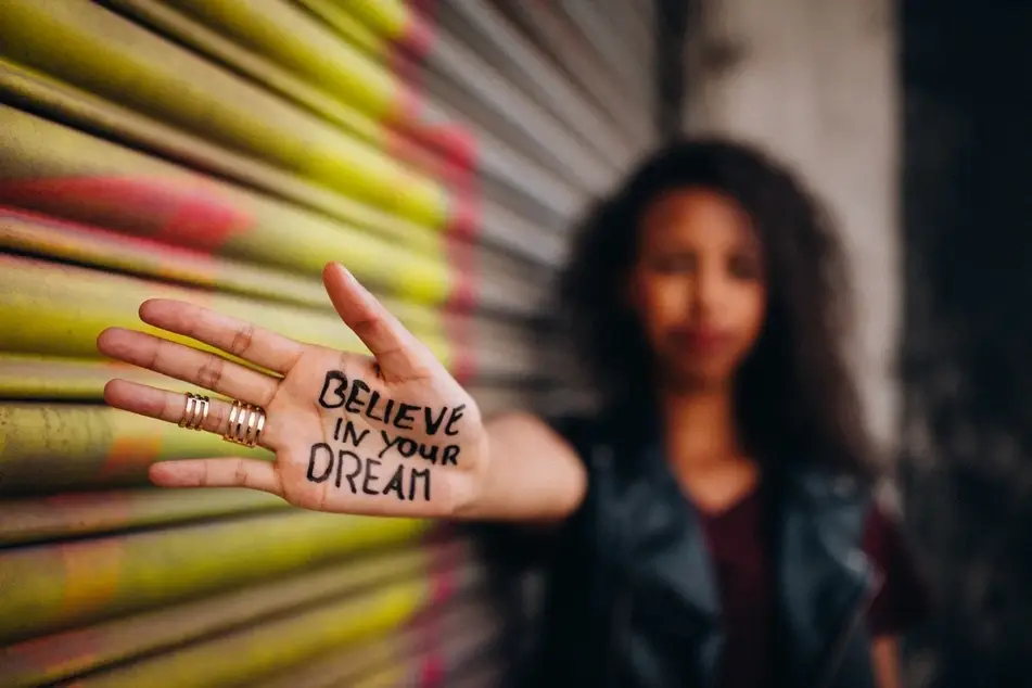 writing on hand believe in your dreams