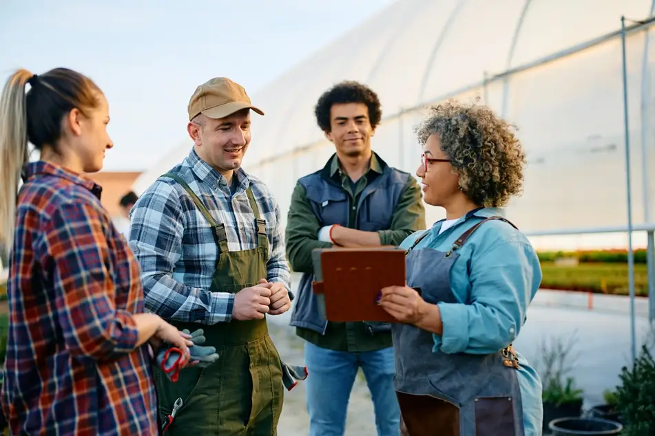 Woman shows checklist to group of volunteers on a community farm