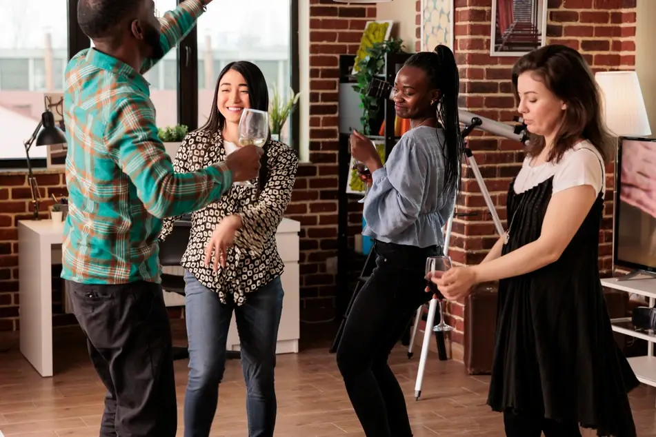 group of volunteers dances together in office