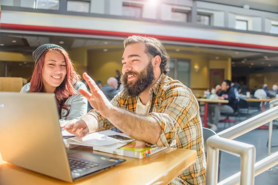 woman and man working together at laptop