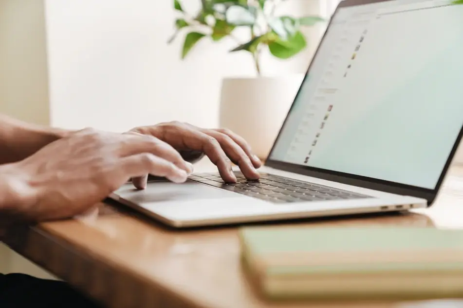 Man uses laptop for volunteer engagement strategy