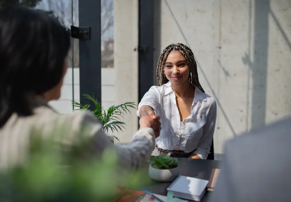 Woman shakes hand at work