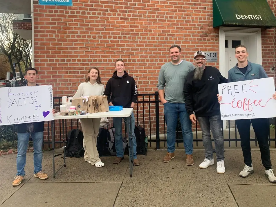 A group of individuals from Hope Community in Brooklyn, NY hand out free coffee and donuts to neighbors.