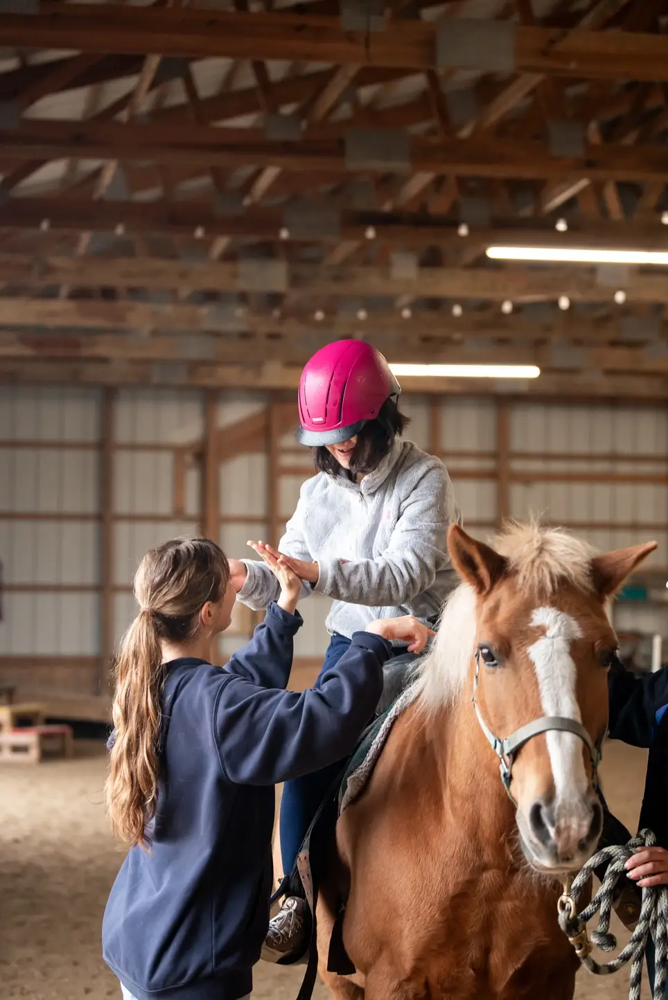 Volunteer with therapeutic riding students