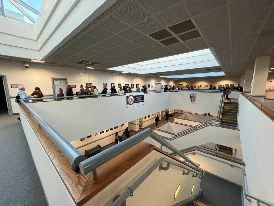 Hanging artwork for high school student art show